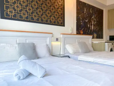 a bedroom with two beds with white sheets at Tropicana 218 Macalister by YueLai Inn in George Town