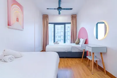 a bedroom with two beds and a desk and a window at Tropicana 218 Macalister by YueLai Inn in George Town