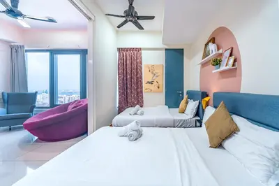 a hotel room with two beds and a couch at Tropicana 218 Macalister by YueLai Inn in George Town