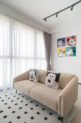 a living room with a couch in front of a window at Mickey's Magic Urban Suites Jelutong Penang, Seaview in Jelutong