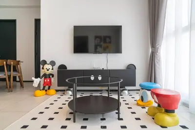 a living room with a table and some toys at Mickey's Magic Urban Suites Jelutong Penang, Seaview in Jelutong