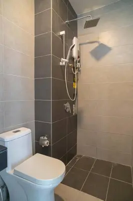 a bathroom with a toilet and a shower at Mickey's Magic Urban Suites Jelutong Penang, Seaview in Jelutong