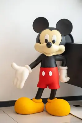 a figurine of a mickey mouse standing on a table at Mickey's Magic Urban Suites Jelutong Penang, Seaview in Jelutong
