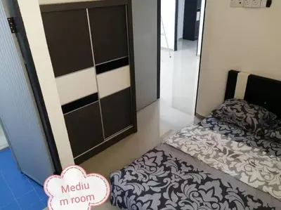 a small bedroom with a bed and a door at Simpang Ampat QQ in Simpang Ampat