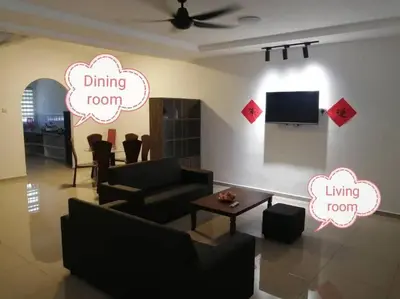 a living room with a couch and a table at Simpang Ampat QQ in Simpang Ampat