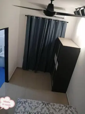 a bedroom with a black curtain and a black dresser at Simpang Ampat QQ in Simpang Ampat