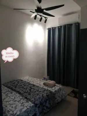 a bedroom with a bed and a ceiling fan at Simpang Ampat QQ in Simpang Ampat