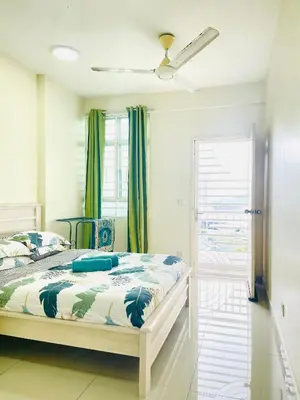a bedroom with a bed and a window at Arena Spice Guesthouse in Bayan Lepas