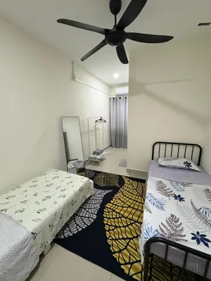 a bedroom with two beds and a ceiling fan at AFA Home KKB in Kuala Kubu Baharu