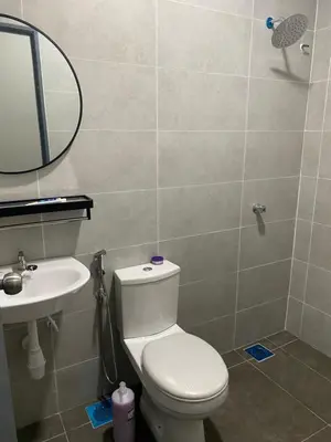 a bathroom with a toilet and a sink and a mirror at AFA Home KKB in Kuala Kubu Baharu