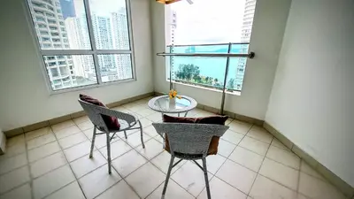 a room with two chairs and a table and two windows at Mansion One George Town - Spacious Studio 1 bathroom type in George Town