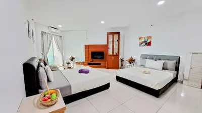 a hotel room with two beds and a television at Mansion One George Town - Spacious Studio 1 bathroom type in George Town