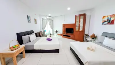a large white room with two beds and a couch at Mansion One George Town - Spacious Studio 1 bathroom type in George Town