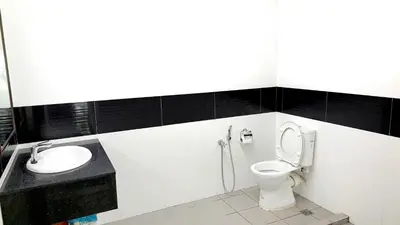 a bathroom with a toilet and a sink at Mansion One George Town - Spacious Studio 1 bathroom type in George Town