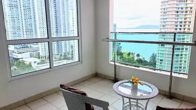 a table and chairs in a room with windows at Mansion One George Town - Spacious Studio 1 bathroom type in George Town