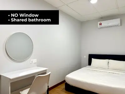 a bedroom with a bed and a mirror and a sink at Lili Stay by the beach in George Town