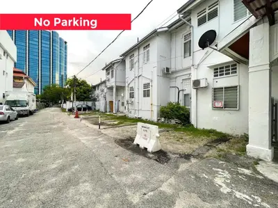 a no parking sign sitting on the side of a street at Lili Stay by the beach in George Town
