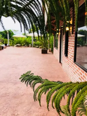a courtyard with a brick building and a palm tree at EFM GREENLAND IPOH in Ipoh