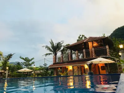 a resort with a swimming pool and a house at EFM GREENLAND IPOH in Ipoh