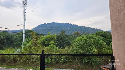 a view of a mountain from a black fence at Ruzarani Home Meru Suria in Chemor