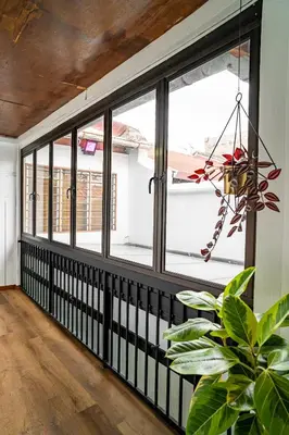 a room with windows and a potted plant at Caryn Vintage Guesthouse in George Town