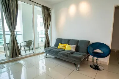 a living room with a couch and a blue chair at Seaview mansion one Georgetown Penang in George Town
