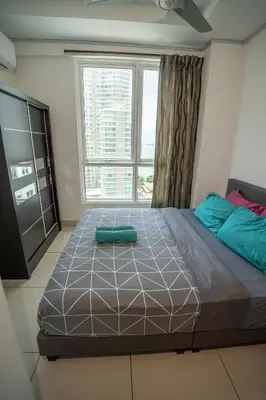 a large bed in a room with a large window at Seaview mansion one Georgetown Penang in George Town