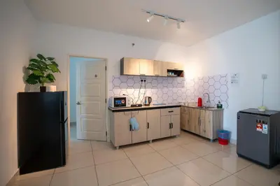 a kitchen with a black refrigerator and wooden cabinets at Seaview mansion one Georgetown Penang in George Town