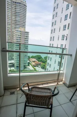 a chair sitting in front of a large window at Seaview mansion one Georgetown Penang in George Town