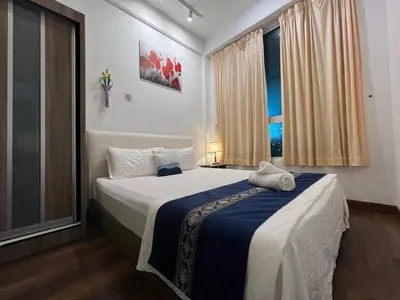 a bedroom with a large bed and a window at D Festivo Residences Ipoh in Ipoh