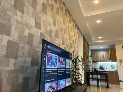 a wall with a large screen in a living room at D Festivo Residences Ipoh in Ipoh