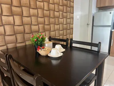a black table with a basket of flowers on it at D Festivo Residences Ipoh in Ipoh