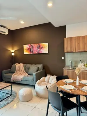 a living room with a couch and a table at Lost World Tambun 1BR 3/4Pax @Sunway Onsen Suite in Kampong Batu Lapan