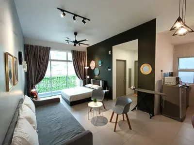 a living room with a couch and a bed at 1BR Cool Homestay at Cameron Golden Hills Night Market in Brinchang