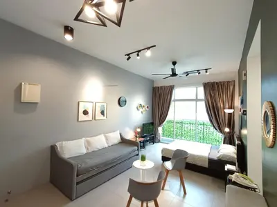 a bedroom with a bed and a table and chairs at 1BR Cool Homestay at Cameron Golden Hills Night Market in Brinchang