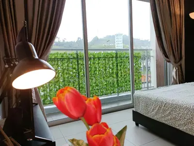 a room with a bed and a window with a flower at 1BR Cool Homestay at Cameron Golden Hills Night Market in Brinchang