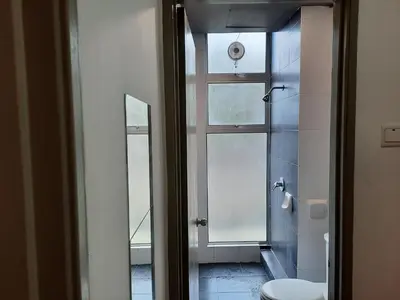 a bathroom with a toilet and a window at 1BR Cool Homestay at Cameron Golden Hills Night Market in Brinchang
