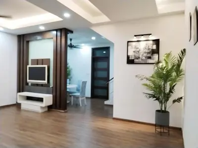 a living room with a tv and a potted plant at 13Pax -2 Storey Bayu Mutiara Bukit Mertajam Penang in Bukit Mertajam
