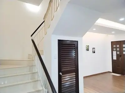 a staircase in a house with a black door at 13Pax -2 Storey Bayu Mutiara Bukit Mertajam Penang in Bukit Mertajam