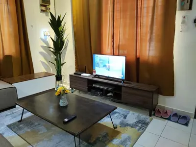 a living room with a tv and a coffee table at CASA AINA at Gopeng Cozy & Comfy Home in Kampong Kepayang