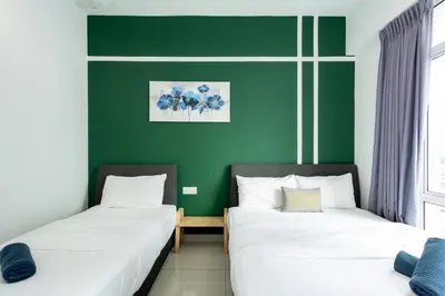 two beds in a room with green walls at Dream - Summer @Majestic Condo in Ipoh
