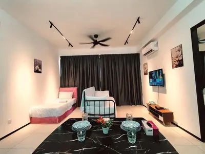 a living room with a bed and a ceiling fan at Georgetown Classic Collection 3BR-10PAX in George Town