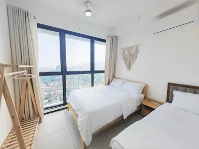 two beds in a room with a large window at 3410 Home4Stay TownArea NewCozyHome InfinityPool in Jelutong