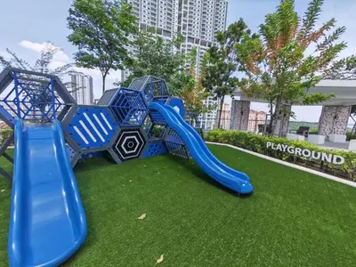 a playground with a blue slide on the grass at 3410 Home4Stay TownArea NewCozyHome InfinityPool in Jelutong