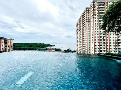 a large pool of water in front of tall buildings at 3410 Home4Stay TownArea NewCozyHome InfinityPool in Jelutong