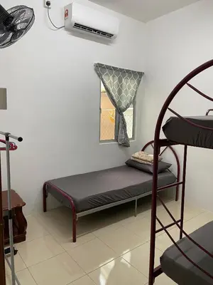 a room with a bunk bed and a window at EmyNuar Homestay in Batu Kurau
