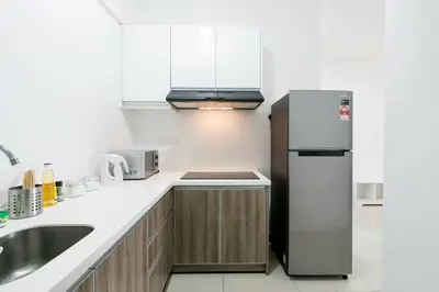 a kitchen with a refrigerator and a sink at Chic - 4 bedroom - Projector - Ipoh Town - Sleep8 in Ipoh