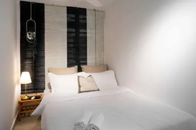 a white bed with white pillows in a bedroom at Chic - 4 bedroom - Projector - Ipoh Town - Sleep8 in Ipoh