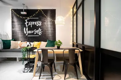 a dining room with a table and a couch at Chic - 4 bedroom - Projector - Ipoh Town - Sleep8 in Ipoh