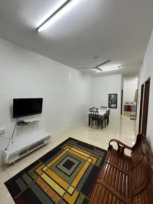 a living room with a couch and a dining room at EmyNuar Homestay in Batu Kurau